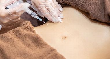 stomach with injection needle hovering above